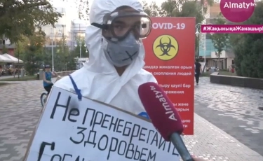 «Карантин режимін сақтаңыздар, менің де демалғым келеді». Алматыда осындай плакат ұстаған белгісіз жан арбатта акция жасады