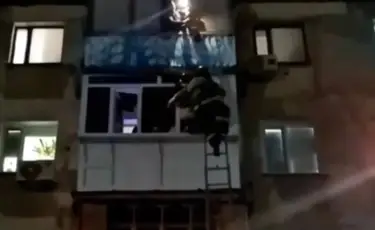 На волоске от трагедии: девушка прыгнула с балкона и повисла между этажами (видео)